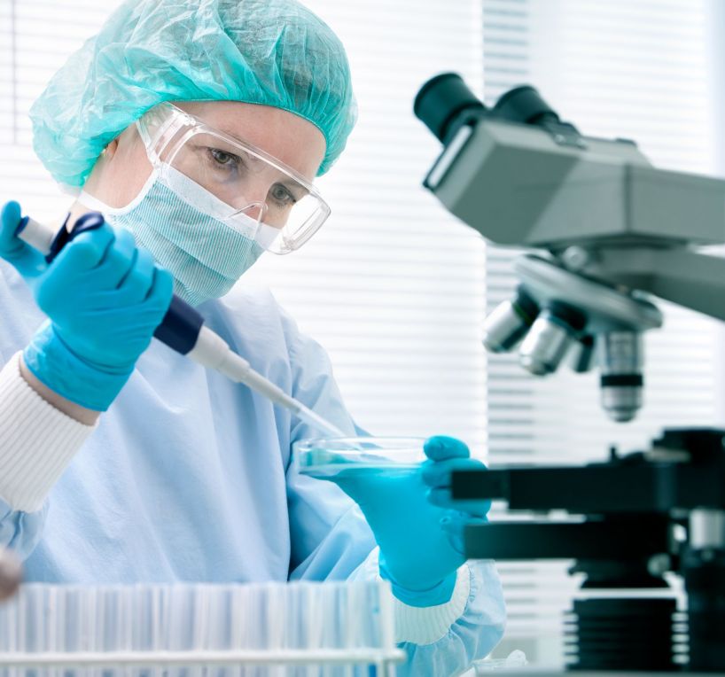 Scientist with dropper working at the laboratory